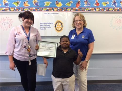 An elementary student winning Student of the Month award. 